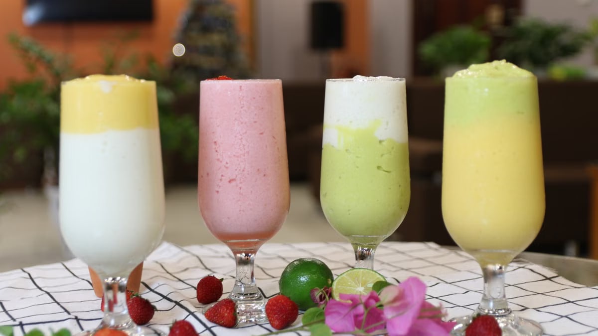 A vibrant array of healthy fruit smoothies in wine glasses, perfect for a balanced diet.